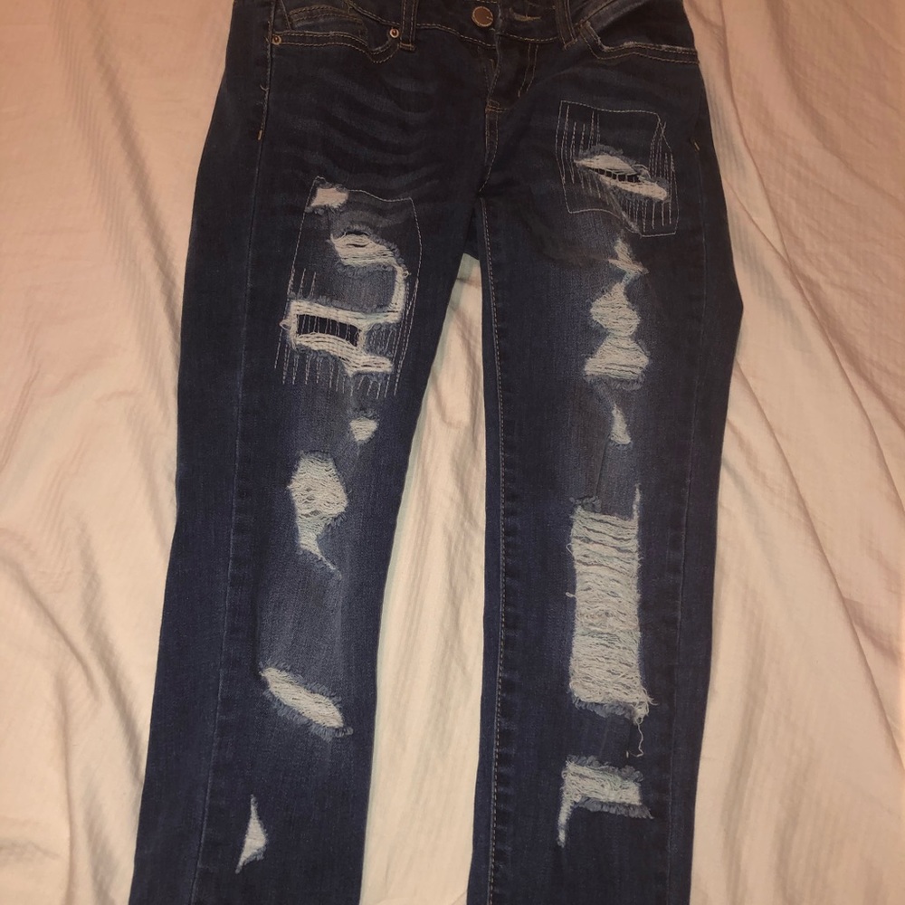 dark wash blue ripped jeans